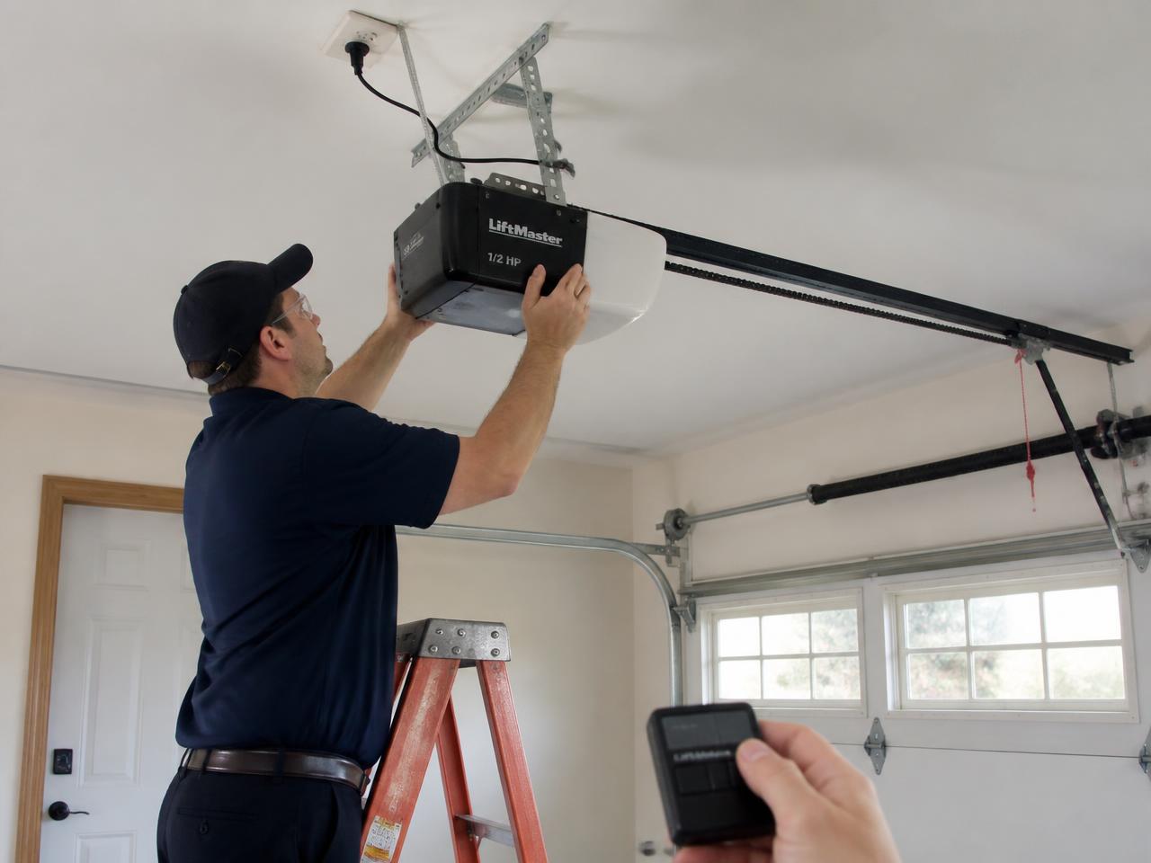Technician installing a ceiling-mounted belt-drive garage door opener